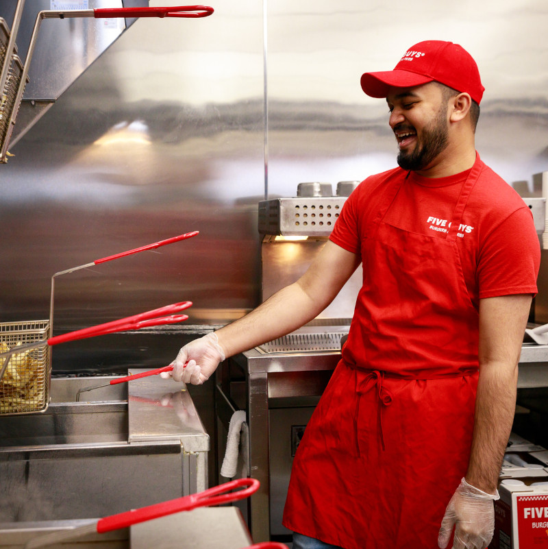 Several Five Guys employees pose
